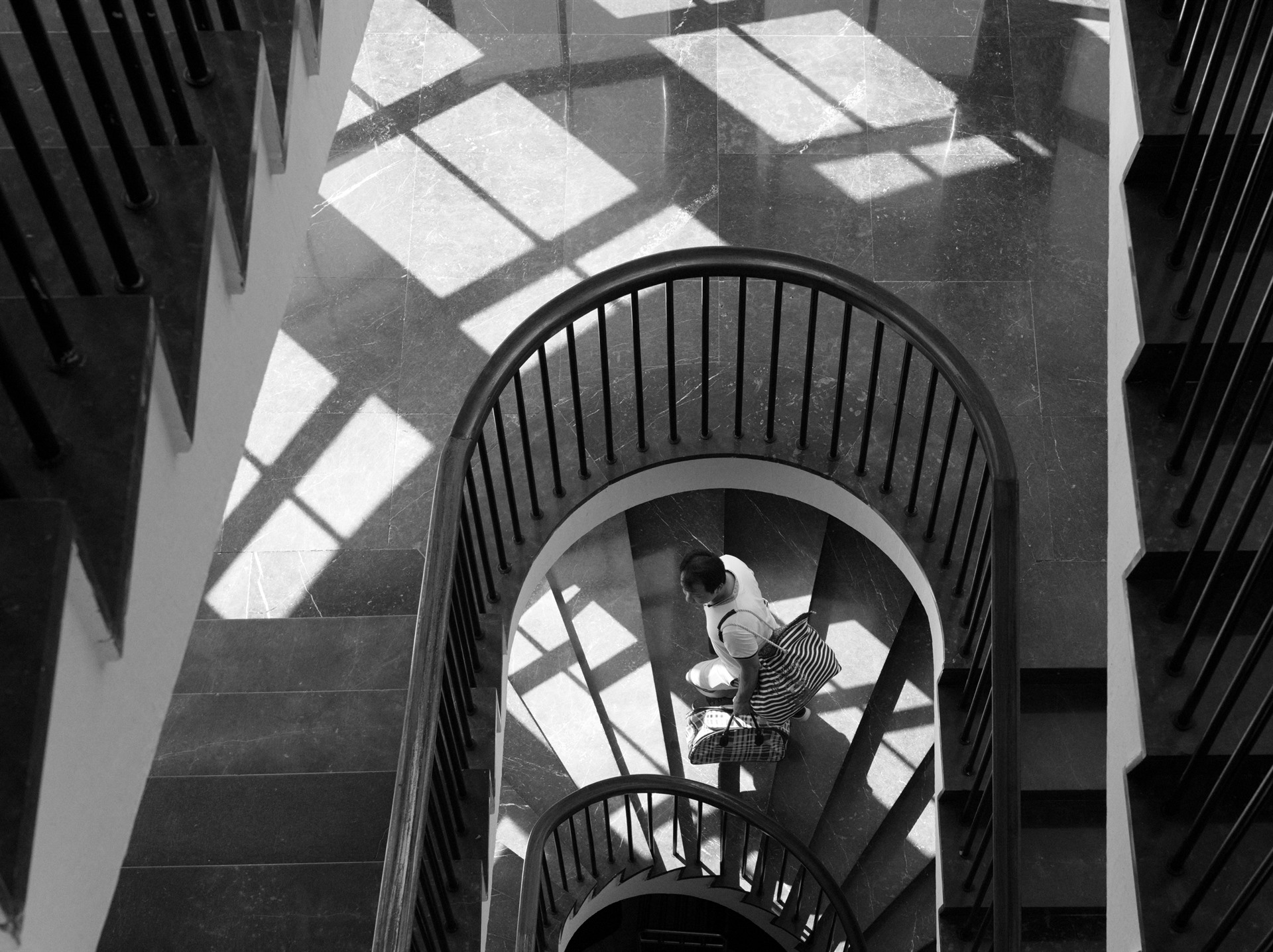 Woman seen from above in a spiral staircase.