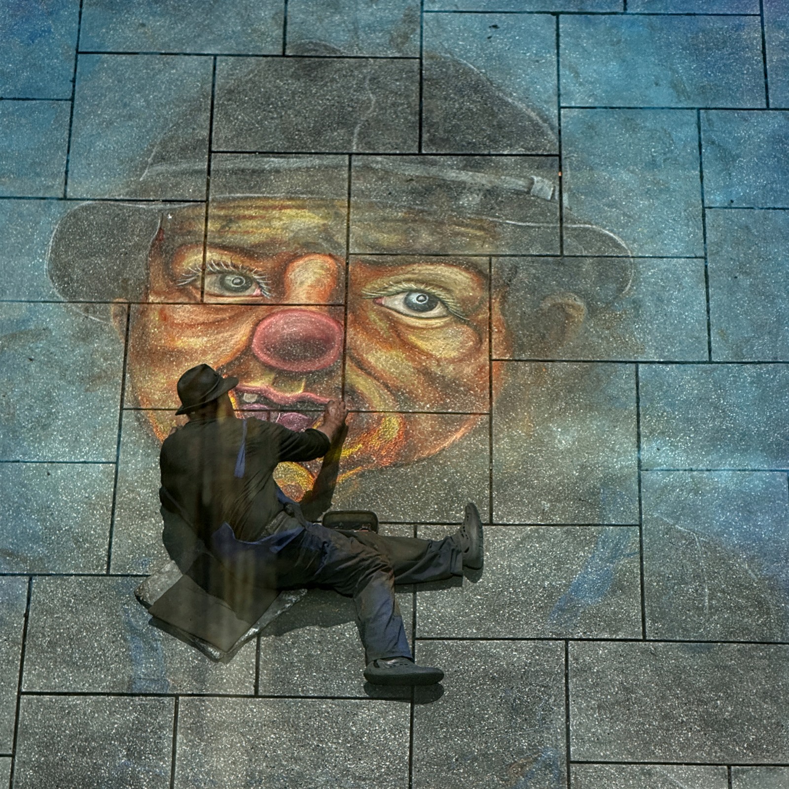 Man aligned with a large painted face.